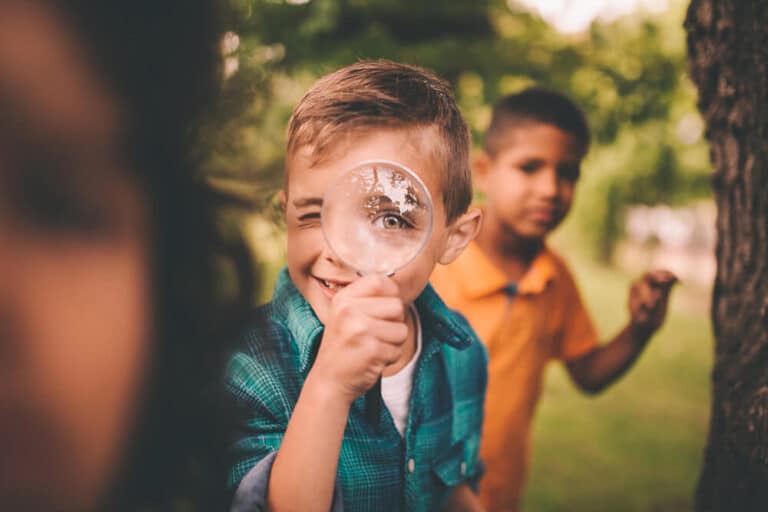 A boy looking through a spy glass at local sites in Center Lake Ranch