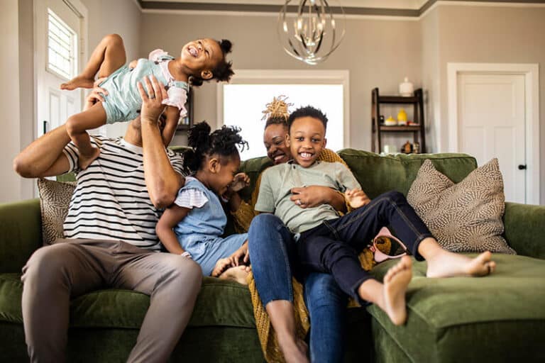 family on a couch in their home at Oakfield FL